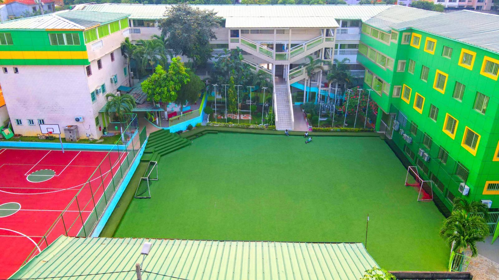 Aerial view of the Morning Glory International School campus in Bingerville, showing the football pitch, basketball court and classroom blocks