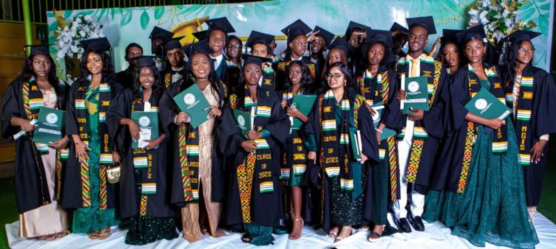 MGIS graduates in gowns and kente stoles at the Class of 2023 graduation ceremony